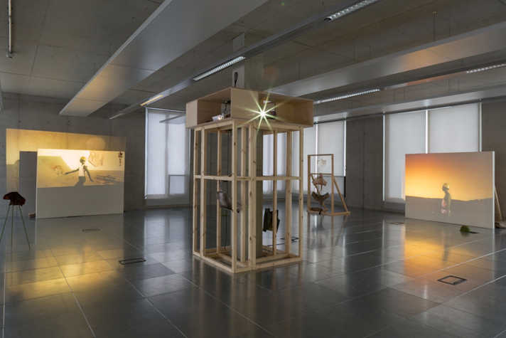 Installation view of a gallery with 2 films projected.