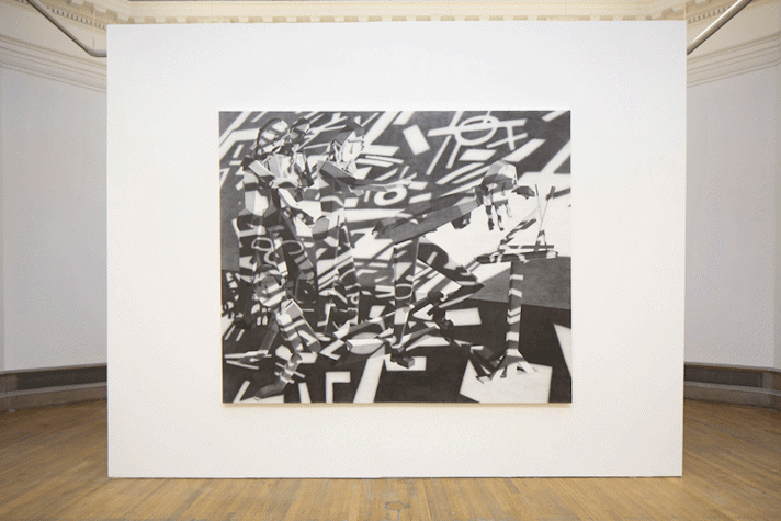A false wall is placed a few feet in front of a wall. The painting on the wall is centrally placed. It has five human like figures, made of geometric shapes. Two of them are in embrace, one is lying down on the floor while another seems to be reading something on a stand in front of them. It is monochromatic and has stark shadows of shapes covering the entire painting, including the figures.