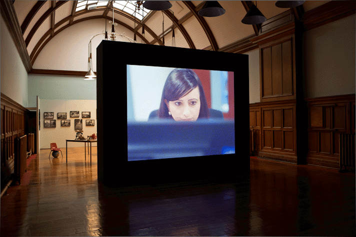 a person looks at a computer screen in a projected film