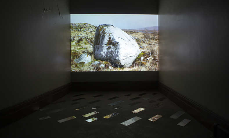 gallery installation, film screen showing landscape images