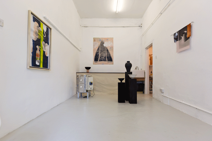 Paintings and ceramics in a small room