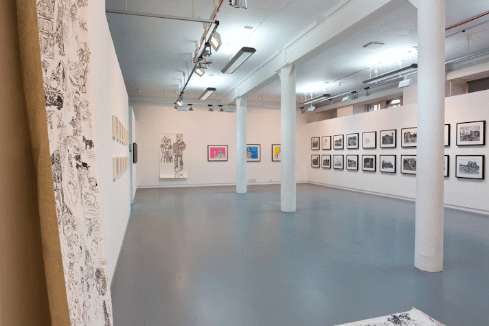 drawings hang on three gallery walls