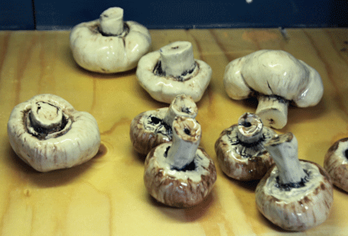 Photo of ceramic mushrooms on a wooden table