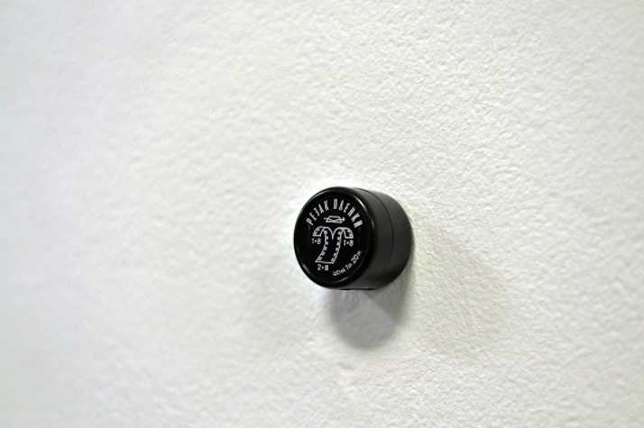 16mm film splitter attached to a white wall