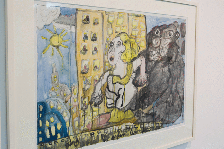 a watercolour showing a playful, cartoon-like image of a large guerilla holding a woman, in the background is a towerblock with people looking out of the windows