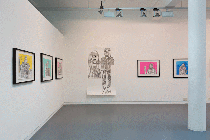 a gallery with drawings hung on the walls