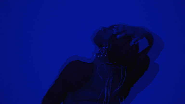 A blurred image of a person with their head thrown back, with a blue overlay.