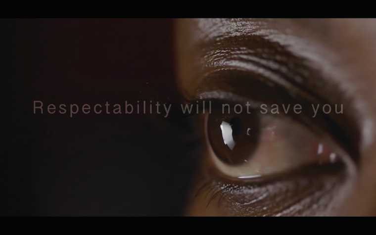 a film still of a brown eye with text overlay that reads 'respectability will not save you'