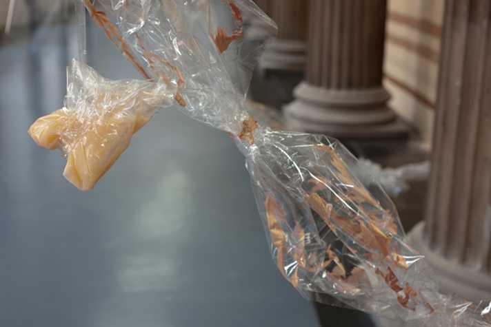 close up of sculpture made from cellophane, with pillars in background