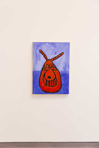 An artwork displayed on a wall. It features a red space hopper with a face.