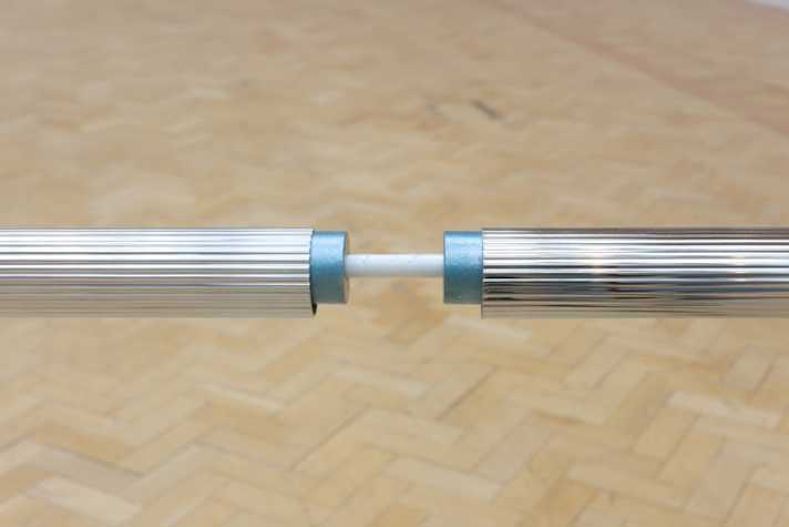 close up of horizontally suspended chrome-coated pipes
