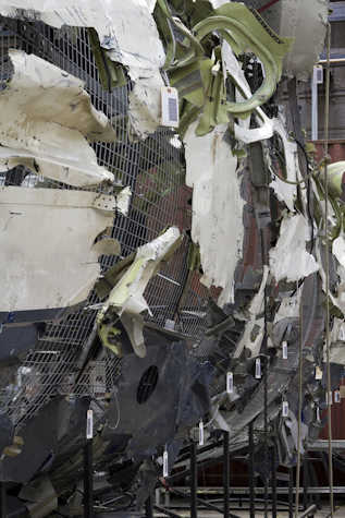 close up of a wreckage of a large commercial airplane that has been reassembled