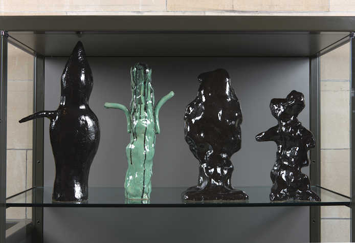 abstract ceramic sculptures in a museum display case
