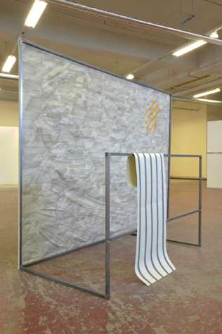 large metal freestanding frame with a screenprinted paper stretched across it.