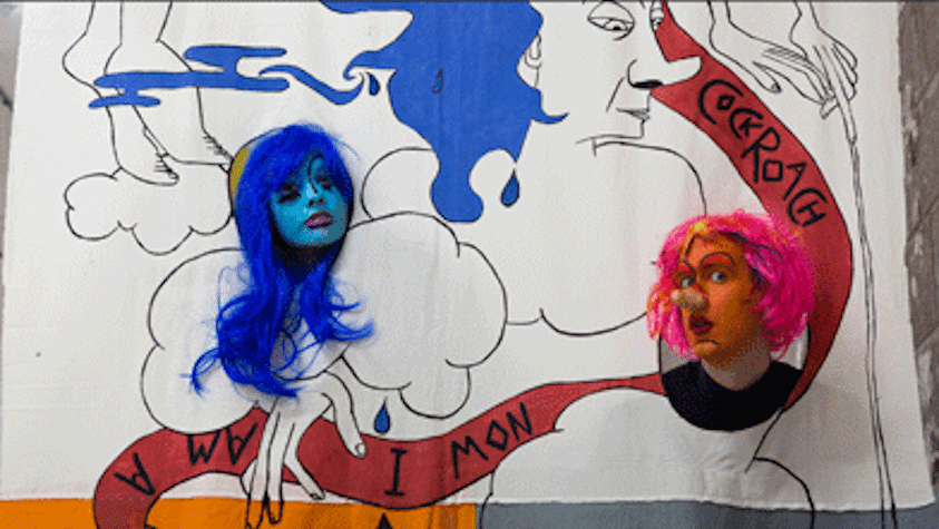 two painted faces with heads through a graphic cloth