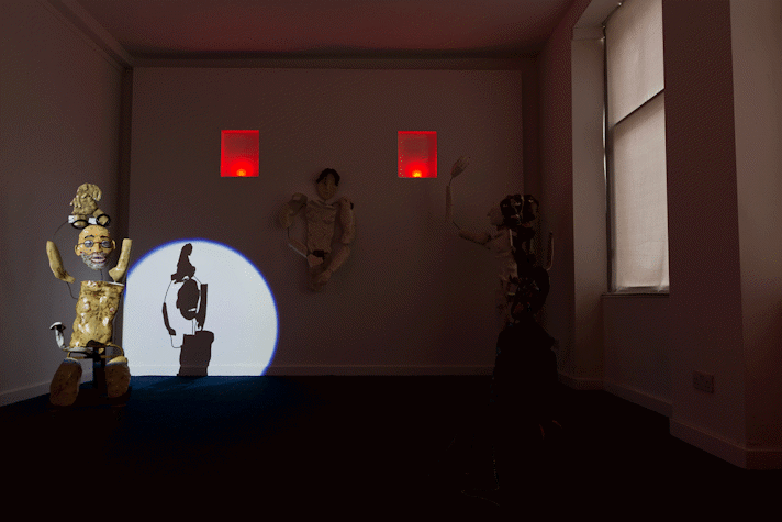 spotlit ceramic figure in dark room