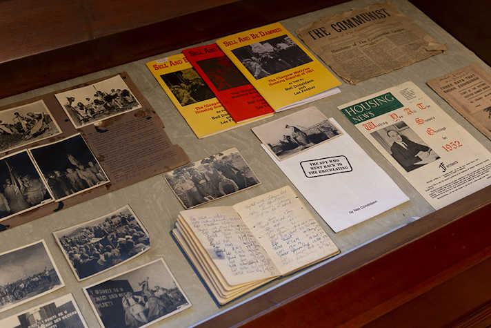 A selection of documents and print in a display cabinet.