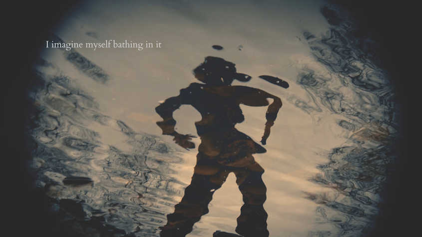 The reflection of a figure on the surface of water