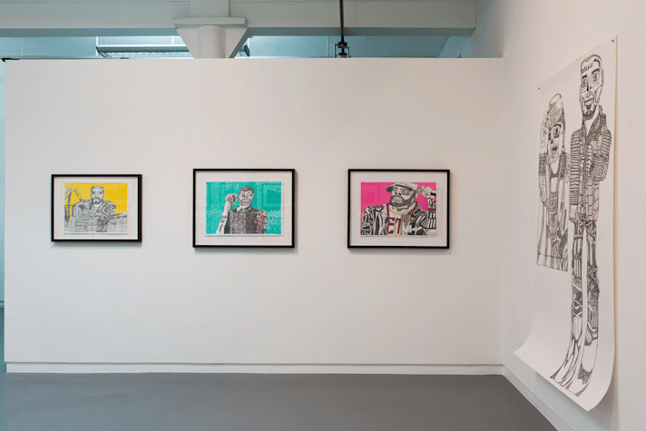 drawings hang on a gallery wall