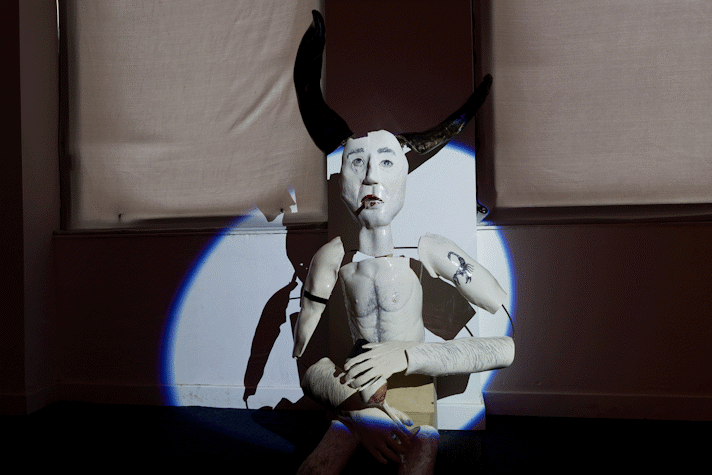 spotlit ceramic figure in dark room