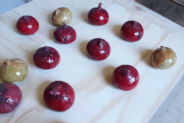 Ceramic onions on a wooden table