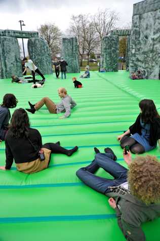 group of people sat on a bouncy castle version of stone henge