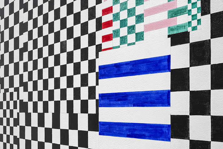A close up of an abstract artwork featuring patterned tiles