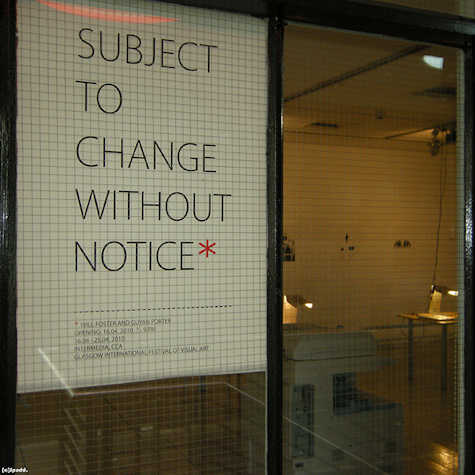 sign shot through a window reading; subject to change without notice