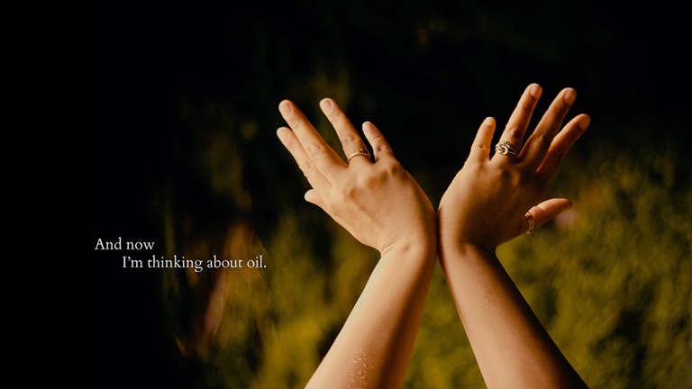 A person's hands held up, splayed at the wrists and outstretched. In small writing it says 'And now I'm thinking about oil'.