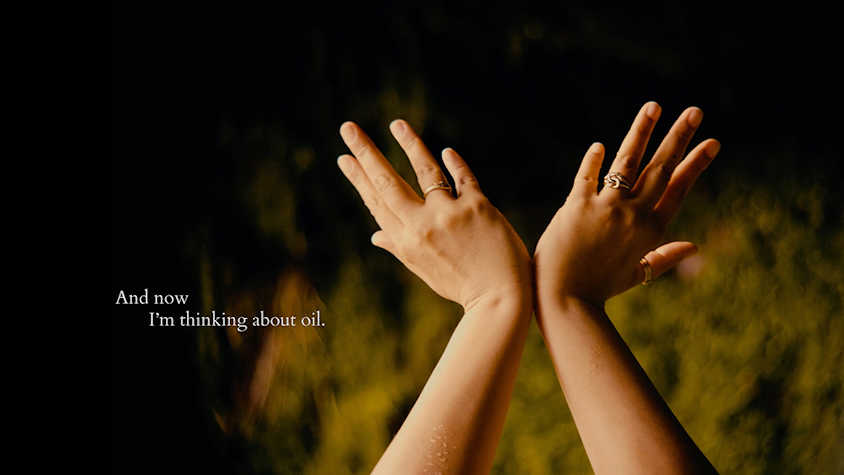 A person's hands held up, splayed at the wrists and outstretched. In small writing it says 'And now I'm thinking about oil'.