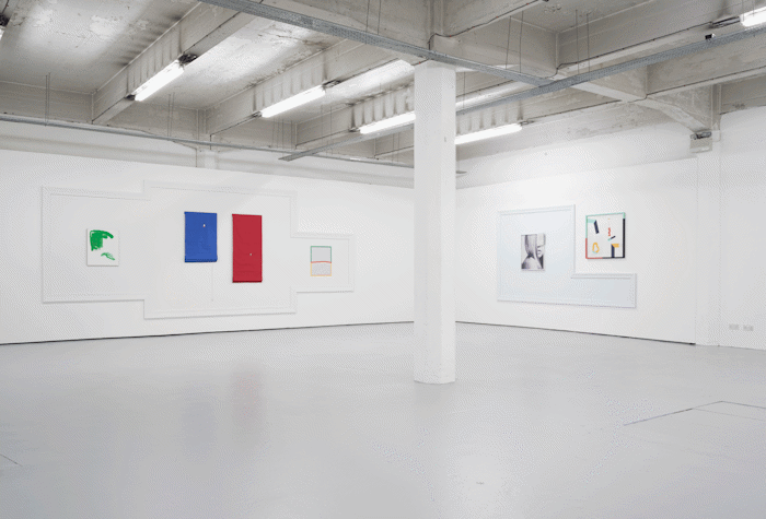 In the corner of the room, there are artworks placed in a single large frame. They are on either side of the pillar placed in the centre of the corner of the wall.