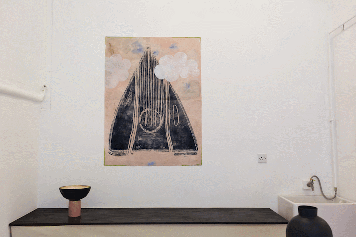 Paintings and ceramics in a small room