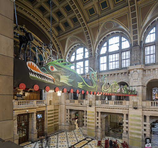 CLose-up view of dragon artwork hanging from side to side in Kelvingrove Art Gallery and Museum in Glasgow International 2018.