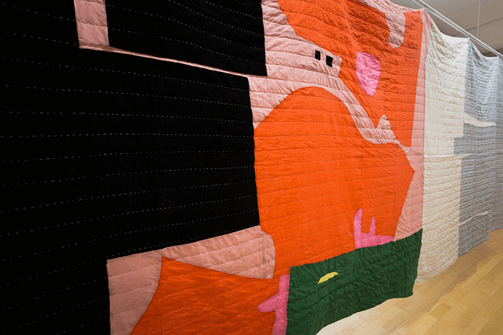 large scale quilt hangings with abstract cut out shapes