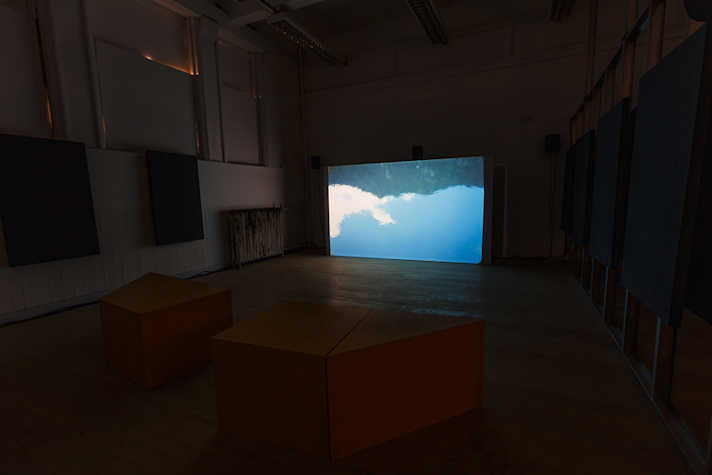 There is a bright screen in a dark room.