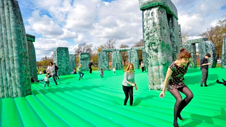 people jumping on a bouncy castle version of Stonehenge