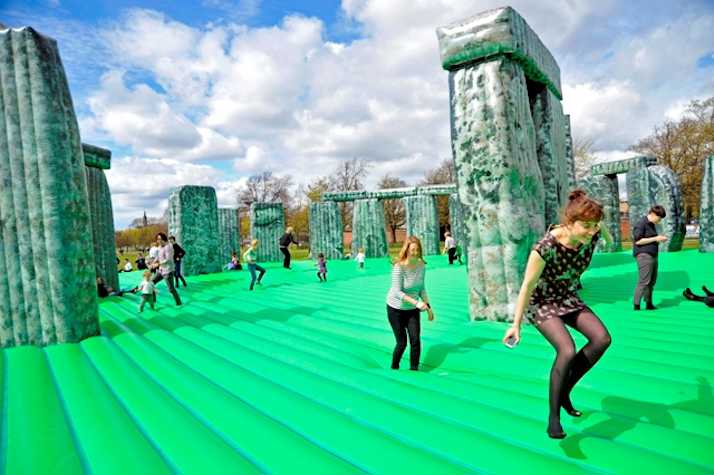 people jumping on a bouncy castle version of Stonehenge