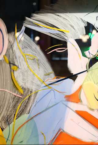 Close up of a painting on glass depicting a face with yellow and pink lines and blocks of pale blue, pink, green and orange below