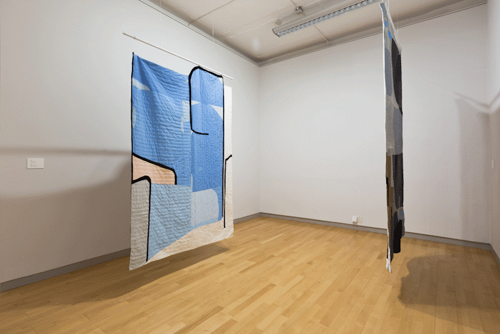large scale quilt hangings with abstract cut out shapes