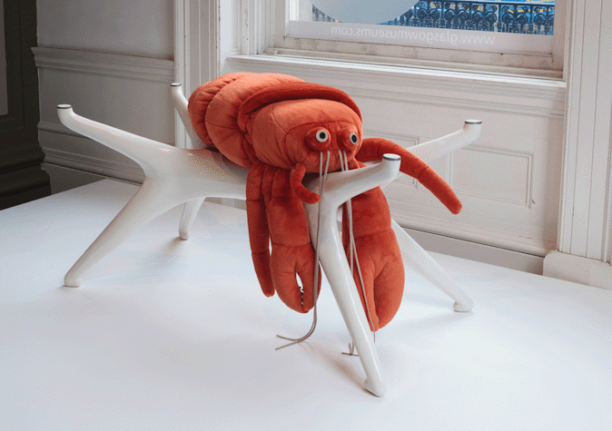 Stuffed red lobster on a white sculptural structure