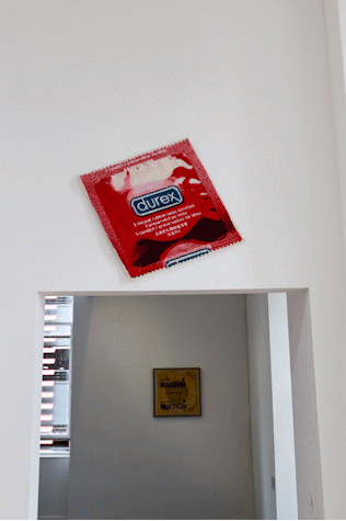 Fabric print of red Pasante condom packet