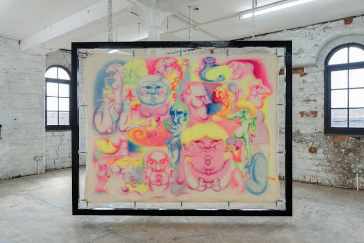 Large painting framed in a black frame and hung from the ceiling with chain. The painting depicts multiple figures in fluorescent paint