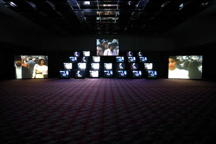 Pile of multiple cube monitors showing film
