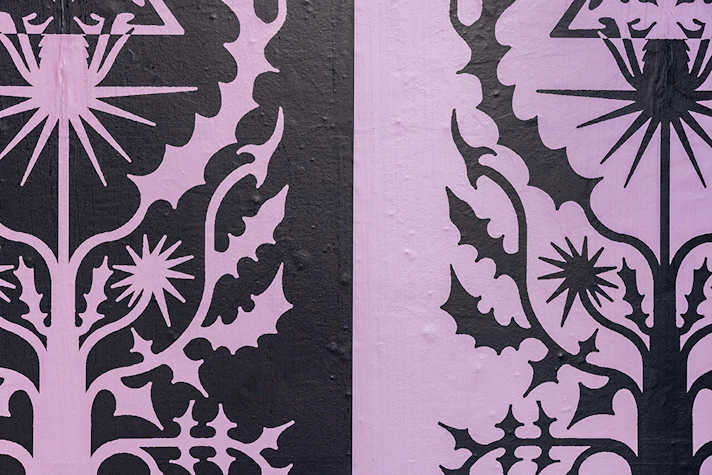 A close-up of pink and black artwork presented side by side. There is a graphic of an abstract tree-like image.