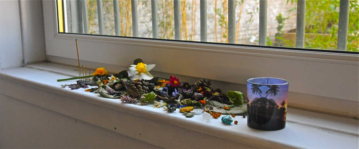 Dried flowers on windowsill with a glass jar