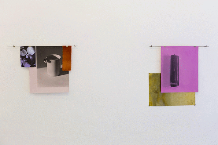 two collage artworks hang on a white wall