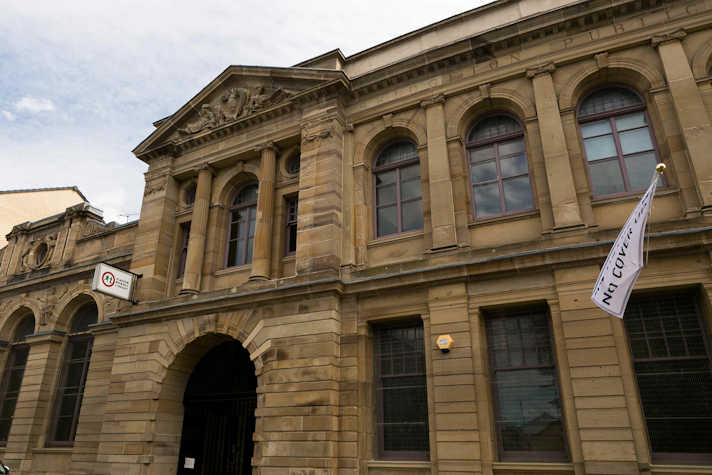 Exterior view of Glasgow Women's Library with a white flag showing the word No Cover Up
