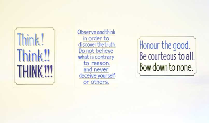 three posters on the wall. the first reads "Think! Think!! Think!!!", the second, "Observe and think in order to discover the truth. Do not believe what is contrary to reason, and never deceive yourself or others.