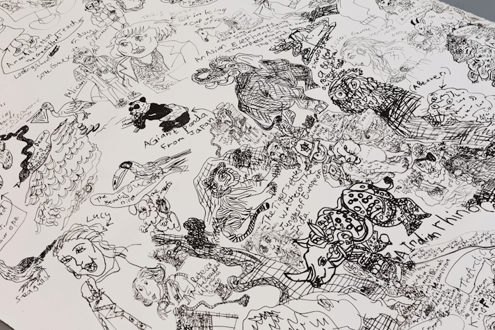detail of intricate black pen drawing showing small animals and figures overlaid